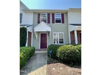 Charming townhouse featuring a stylish front door with a covered entryway and well-maintained landscaping at 7832 Averette Field Dr, Raleigh, NC 27616