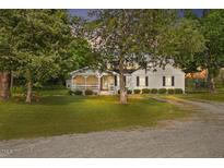 Quaint single-story home with a charming front porch and well-maintained lawn at 784 Crawford Rd, Coats, NC 27521