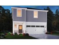 Two-story home featuring a two-car garage, light gray siding, and a landscaped front yard at 800 Ottawa Dr, Garner, NC 27529