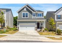 Charming two-story home with a two-car garage and manicured lawn in a suburban community at 1007 Sora Way, Durham, NC 27703