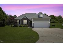 Charming single Gathering home featuring a two-car garage and landscaped front yard at 101 Hazel Ln Ln, Broadway, NC 27505