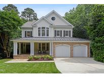 Charming two-story home with a welcoming front porch and a well-manicured lawn at 118 Killingsworth Dr, Cary, NC 27518