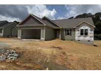 New construction featuring neutral siding, a covered entrance and an attached two-car garage at 145 Tee Dr, Selma, NC 27576