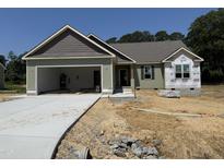 Charming single-story home featuring an attached two-car garage and lovely architectural details at 145 Tee Dr, Selma, NC 27576