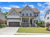 Charming two-story home featuring manicured lawn, wood accents, and an attached two-car garage at 1716 Aberdour Dr, Apex, NC 27502