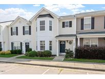 Inviting townhouse featuring a well-manicured lawn and neutral siding, creating a cozy curb appeal at 1966 Grassy Banks Dr, Raleigh, NC 27610