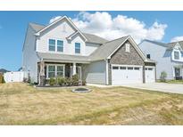 Two story home featuring stone accents, white siding, and a two car garage at 254 Arlie Ln, Lillington, NC 27546
