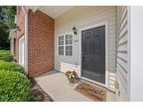 Charming front entrance with brick accent, black door, and welcome mat at 285 Plaza Dr # C, Chapel Hill, NC 27517