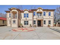Stunning multi-Gathering home featuring a grand facade, balconies, and manicured landscaping for sophisticated curb appeal at 318 W Lillington St, Angier, NC 27501