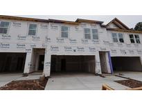 View of new construction townhomes featuring a garage and large windows at 7102 Hubner Pl # 46, Cary, NC 27519