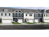 View of newly constructed townhomes featuring a mix of colors and single-car garages at 8763 Wardle Ct, Wake Forest, NC 27587