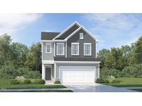 Beautiful two-story home featuring attached two-car garage and professionally landscaped yard at 1009 Red Roses Ave, Durham, NC 27703