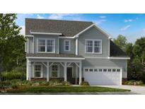Charming two-story home with a covered porch and a two-car garage provides a welcoming curb appeal at 1032 Sun Springs Rd, Wake Forest, NC 27587