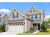 Charming two-story home with gray siding, blue shutters, manicured lawn, and an attached two-car garage at 108 White Burley Ct, Durham, NC 27703