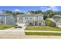 Charming two-story home with a well-manicured lawn and attached two car garage at 1100 Balsawood Dr # 5, Durham, NC 27705