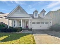 Charming single-Gathering home with a well-manicured lawn, a two car garage, and a welcoming front porch at 120 Martingale Dr, Holly Springs, NC 27540