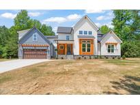Stunning two-story home featuring mixed siding, a two-car garage and pristine landscaping at 120 Pilot Ridge Rd, Zebulon, NC 27597
