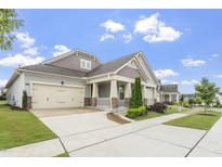 Charming one-story home with a two-car garage, landscaped yard, and covered porch at 1205 Steinbeck Dr, Durham, NC 27703