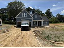 Charming, new construction home featuring a two car garage and covered front porch in a quiet neighborhood at 183 Tee Dr, Selma, NC 27576