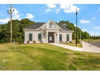 Attractive single story building with dark grey roof, light facade, and well manicured lawn at 23 Paper Birch Trl # 145, Garner, NC 27529
