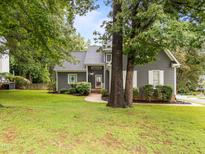 Charming single-Gathering home features a well-manicured front yard and mature trees at 2913 Coxindale Dr, Raleigh, NC 27615