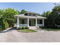 Charming single-story home with green shutters, a large front porch, and manicured landscaping at 308 W Whitaker Mill Rd, Raleigh, NC 27608