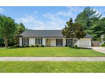 Charming single-story home with manicured lawn, mature tree, and welcoming curb appeal at 401 Wyndham Drive, Fuquay Varina, NC 27526