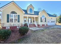 Charming single-Gathering home with a well-manicured front yard and attached two car garage at 414 Ash Lily Ct, Nashville, NC 27856
