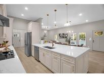 Bright, open kitchen with large island, modern appliances, and stylish pendant lighting creates an inviting space at 516 Ottawa Ave, Durham, NC 27701