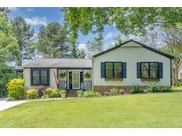 Charming single-story home featuring a well-manicured lawn and inviting front porch at 5617 Groomsbridge Ct, Raleigh, NC 27612