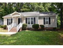 Charming single-story home with a welcoming porch and well-maintained landscaping at 5949 Sandy Run, Knightdale, NC 27545