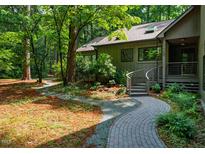 Charming home exterior with landscaped walkway and mature trees at 128 Shadowbrook, Pittsboro, NC 27312