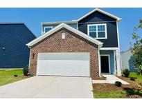 Charming two-story home with brick accents, a well-maintained lawn, and a two-car garage at 139 N Keatts Winner Ct, Wilson's Mills, NC 27520