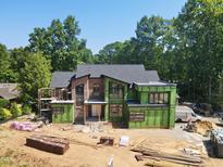 Modern two-story home under construction with brick accents and a well-maintained yard at 1925 Hunting Ridge Rd, Raleigh, NC 27615