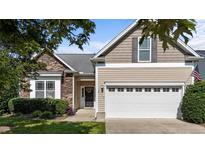 Charming home featuring a stone facade, neutral siding, a two-car garage, and manicured landscaping at 2117 Crockett Ridge Rd, Fuquay Varina, NC 27526