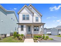 Charming two-story home with a covered front porch and beautifully landscaped front yard at 212 Aubey Ln, Wake Forest, NC 27587