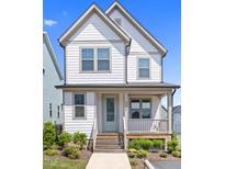 Charming two-story home with welcoming front porch and well-maintained landscaping at 212 Aubey Ln, Wake Forest, NC 27587