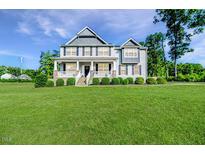 Charming two-story home with a large front yard and inviting covered porch at 2802 Bingham Dr, Mebane, NC 27302
