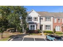 Charming townhome featuring stone accents, neutral siding, and a well-manicured lawn in a desirable community at 2821 Corbett Grove Dr, Raleigh, NC 27604