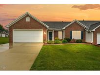 Charming brick home with manicured lawn and attached two-car garage, offering great curb appeal at 3027 Maple # T1, Burlington, NC 27215