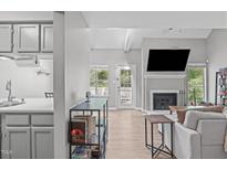 Bright living room features hardwood floors, a modern fireplace, and an abundance of natural light at 405 Gooseneck Dr # B6, Cary, NC 27513