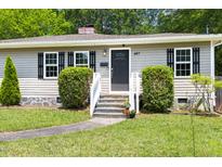 Charming home featuring a welcoming front entrance with well-maintained landscaping and stylish front door at 407A Edward St, Durham, NC 27701