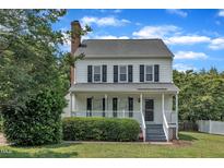 Charming two-story home with a welcoming front porch and well-maintained landscaping at 6221 Winter Spring Dr, Wake Forest, NC 27587