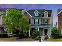 Charming townhouse with a landscaped front yard and inviting entryway, perfect for a cozy Gathering home at 732 Keystone Park Dr, Morrisville, NC 27560