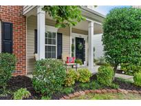 Charming front porch with comfortable seating and lovely landscaping at 732 Keystone Park Dr, Morrisville, NC 27560