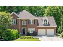 Charming brick home featuring manicured landscaping, a two-car garage, and classic architectural details at 904 Oldwyck Dr, Fuquay Varina, NC 27526