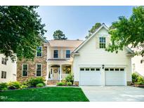 Charming two-story home with a manicured lawn and a two-car garage at 9136 Palm Bay Cir, Raleigh, NC 27617