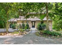 Charming home featuring a gravel driveway and beautifully landscaped front yard at 9507 Sertoma Rd, Chapel Hill, NC 27516