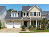 Charming two-story home featuring a two-car garage, well-manicured lawn and covered porch with white pillars at 105 Bridgegate Dr, Cary, NC 27519