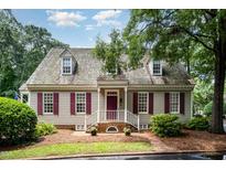 Charming home featuring a cedar shake roof, brick entryway, and well-maintained landscaping at 119 Palace Grn, Cary, NC 27518